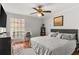 Inviting bedroom with a queen-size bed, a desk, neutral walls, and rustic tile floors at 5558 Kingsport Dr # 27, Atlanta, GA 30342