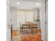 Bright dining area with wood table and chairs, complemented by rustic floors and natural light at 5558 Kingsport Dr # 27, Atlanta, GA 30342