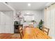 Cozy dining area with wood table, chairs, and rustic floors, connecting to a bright kitchen at 5558 Kingsport Dr # 27, Atlanta, GA 30342
