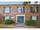 Brick building with a green door and green shutters at 5558 Kingsport Dr # 27, Atlanta, GA 30342