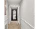 Hallway with neutral carpet, trim, and a full length mirror at 5558 Kingsport Dr # 27, Atlanta, GA 30342