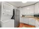 Modern kitchen with stainless appliances, white cabinets, and in-unit laundry at 5558 Kingsport Dr # 27, Atlanta, GA 30342