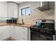 Bright kitchen featuring white cabinets, butcher block counters, and stainless steel appliances at 5558 Kingsport Dr # 27, Atlanta, GA 30342