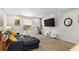 Comfortable living room with plush blue sofa, a TV, neutral walls, and bright natural light at 5558 Kingsport Dr # 27, Atlanta, GA 30342