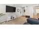 Spacious living room with carpet, a large TV, and a view into the dining area with rustic floors at 5558 Kingsport Dr # 27, Atlanta, GA 30342