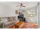 Study with a couch, desk, and terracotta tile flooring at 5558 Kingsport Dr # 27, Atlanta, GA 30342