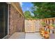 Exterior shot of patio shows brick house, wood fence and access steps at 5558 Kingsport Dr # 27, Atlanta, GA 30342