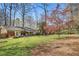 Large backyard with patio area, perfect for outdoor dining and relaxation under mature trees at 933 Vistavia Cir, Decatur, GA 30033