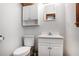 Cozy half bathroom with modern fixtures, a toilet and bright white cabinets at 933 Vistavia Cir, Decatur, GA 30033