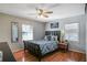 Cozy bedroom with a plush bed, wood floors, natural light and a ceiling fan at 933 Vistavia Cir, Decatur, GA 30033