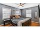 Calm bedroom with hardwood floors, two windows with blinds, and a ceiling fan at 933 Vistavia Cir, Decatur, GA 30033
