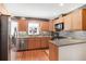 Kitchen featuring wood cabinets, stainless steel appliances, and granite countertops at 933 Vistavia Cir, Decatur, GA 30033