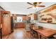 Eat-in kitchen with wooden cabinets, hardwood floors, stainless steel appliances, and a charming nautical painting at 933 Vistavia Cir, Decatur, GA 30033