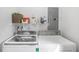 Well-organized laundry area with modern washer and dryer, plus storage shelving at 933 Vistavia Cir, Decatur, GA 30033