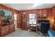 This is a cozy home office with wood paneling and a neutral carpet at 933 Vistavia Cir, Decatur, GA 30033