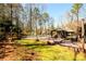Beautiful backyard with a pool, hot tub, gazebo, tall trees, and well maintained grass at 1435 Jay Ct, Snellville, GA 30078