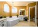 Elegant bathroom with a jetted tub, dual vanities, and neutral color palette at 1435 Jay Ct, Snellville, GA 30078