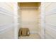 A walk-in closet with shelving on the walls with a cushion at the bottom at 1435 Jay Ct, Snellville, GA 30078