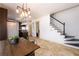 Dining area includes stone tile floors and industrial modern chandelier at 1435 Jay Ct, Snellville, GA 30078