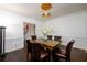 Formal dining room featuring hardwood floors, wainscoting, and modern lighting fixture at 1435 Jay Ct, Snellville, GA 30078