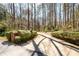 Long driveway lined with mature trees and landscaping leading to the property at 1435 Jay Ct, Snellville, GA 30078