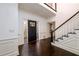 Welcoming foyer with dark wood floors, staircase, and decorative glass front door at 1435 Jay Ct, Snellville, GA 30078