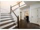 Elegant staircase with hardwood floors, white risers and wainscoting at 1435 Jay Ct, Snellville, GA 30078