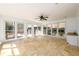 Bright sunroom features tile floor, ceiling fan, and large windows offering beautiful views at 1435 Jay Ct, Snellville, GA 30078