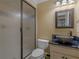Bathroom featuring a patterned vessel sink, black countertop, toilet, and frameless glass shower door at 2554 Emerald Dr, Jonesboro, GA 30236