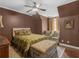 Cozy bedroom with ceiling fan, sitting area, and upholstered bench at 2554 Emerald Dr, Jonesboro, GA 30236