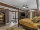 A bedroom with a four-poster bed, bay windows, brown walls, and tile flooring at 2554 Emerald Dr, Jonesboro, GA 30236