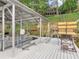 Covered boat dock with boat lift, multiple slips for pontoon boats, waterfront home, and lush green trees at 2554 Emerald Dr, Jonesboro, GA 30236