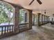 Spacious covered stone patio with views of the lake offers beautiful stone archways, columns, and ceiling fans at 2554 Emerald Dr, Jonesboro, GA 30236