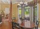 Charming dining area with hardwood floors, chandelier, and large windows offering beautiful views at 2554 Emerald Dr, Jonesboro, GA 30236