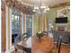 Elegant dining room features a chandelier, hardwood floors, and a bay window overlooking the property at 2554 Emerald Dr, Jonesboro, GA 30236
