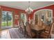 Formal dining room with windows, red walls, chandelier, and large wood table offers an elegant space at 2554 Emerald Dr, Jonesboro, GA 30236