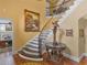 Grand foyer with curved staircase, hardwood floors, and elegant decor at 2554 Emerald Dr, Jonesboro, GA 30236