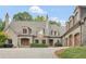 Luxury stone house showcasing elegant curb appeal with manicured greenery at 2554 Emerald Dr, Jonesboro, GA 30236