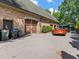 Attached three-car garage with a brick facade and an extra parking pad at 2554 Emerald Dr, Jonesboro, GA 30236