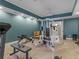 A home gym featuring a variety of exercise equipment and a foosball table on tile floor at 2554 Emerald Dr, Jonesboro, GA 30236