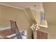 Hallway with wood floors and a decorative chandelier hanging from the ceiling at 2554 Emerald Dr, Jonesboro, GA 30236