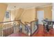 Hallway with wood floors, iron railing, and view of the main level at 2554 Emerald Dr, Jonesboro, GA 30236