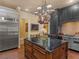 Chef's kitchen featuring a large island with cooktop, stainless steel appliances, and custom cabinetry at 2554 Emerald Dr, Jonesboro, GA 30236