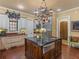 Gourmet kitchen featuring a large island with a sink, custom cabinets, and stainless steel appliances at 2554 Emerald Dr, Jonesboro, GA 30236