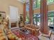 Bright living room boasts a fireplace, hardwood floors, and large windows overlooking the backyard at 2554 Emerald Dr, Jonesboro, GA 30236