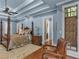 Comfortable main bedroom with a four-poster bed, blue walls, tray ceiling, and ample natural light creates a serene retreat at 2554 Emerald Dr, Jonesboro, GA 30236