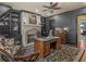 Office featuring a stone fireplace, dark trim, built-in bookcases, and executive desk at 2554 Emerald Dr, Jonesboro, GA 30236