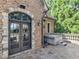 Stone patio with an arched doorway, stone railing, and a hot tub in the corner at 2554 Emerald Dr, Jonesboro, GA 30236