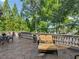 Outdoor patio with stone balustrade, decorative planters, lake views, and cushioned chaise lounge at 2554 Emerald Dr, Jonesboro, GA 30236