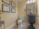 Powder room with decorative mirror, vanity, and tiled floor at 2554 Emerald Dr, Jonesboro, GA 30236